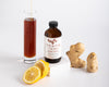 Ginger Honey syrup by Cocktail and Sons sitting between it's two key ingredients; ginger and honey! 